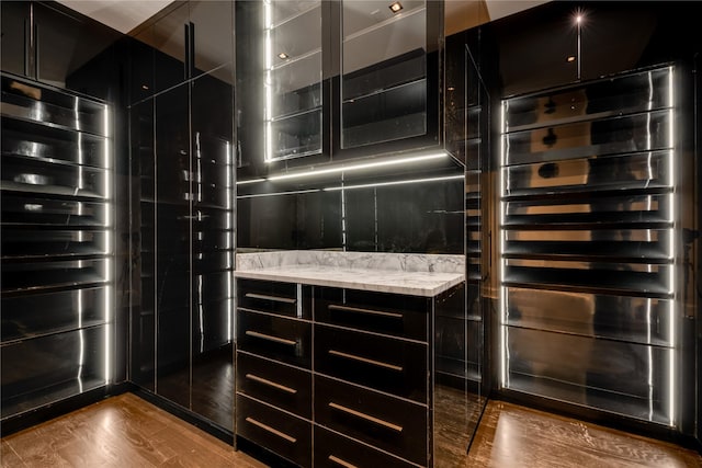 interior details featuring decorative backsplash and wood finished floors