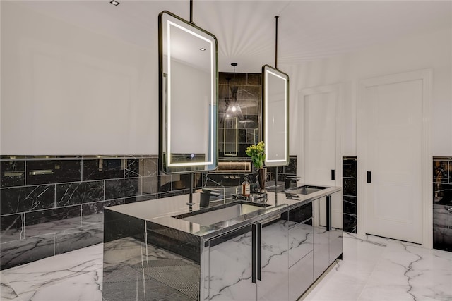 full bathroom featuring a sink, marble finish floor, and double vanity