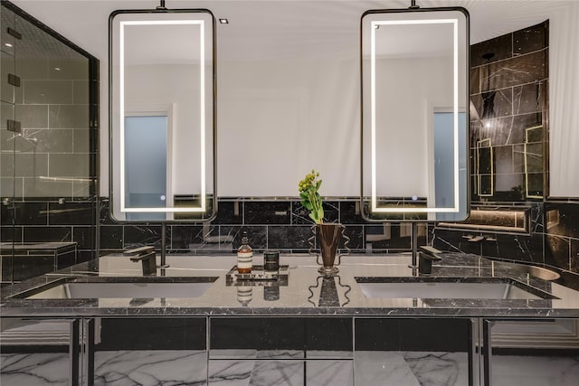 bathroom with double vanity, decorative backsplash, and a sink