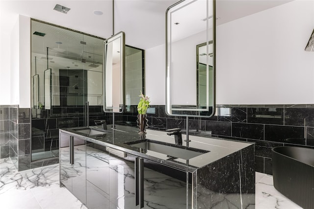 6404 Lakehurst Ave, Dallas, TX 75230 - bathroom featuring a soaking tub, marble tiled flooring, tile walls, a stall shower, and double vanity