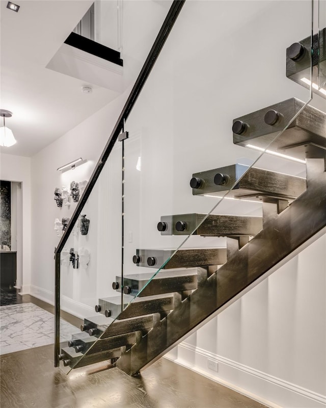 wine room featuring marble finish floor and baseboards