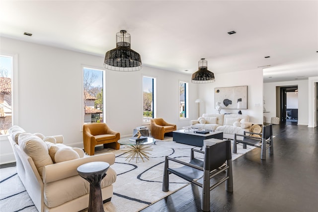 6404 Lakehurst Ave, Dallas, TX 75230 - living area featuring healthy amount of natural light, wood finished floors, and baseboards