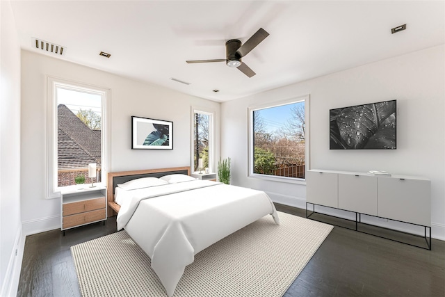 6404 Lakehurst Ave, Dallas, TX 75230 - bedroom with multiple windows, baseboards, and wood finished floors