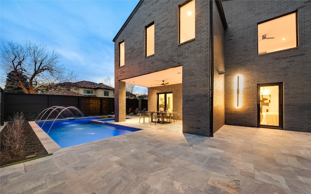 view of pool featuring a patio, outdoor dining area, a fenced backyard, and a fenced in pool