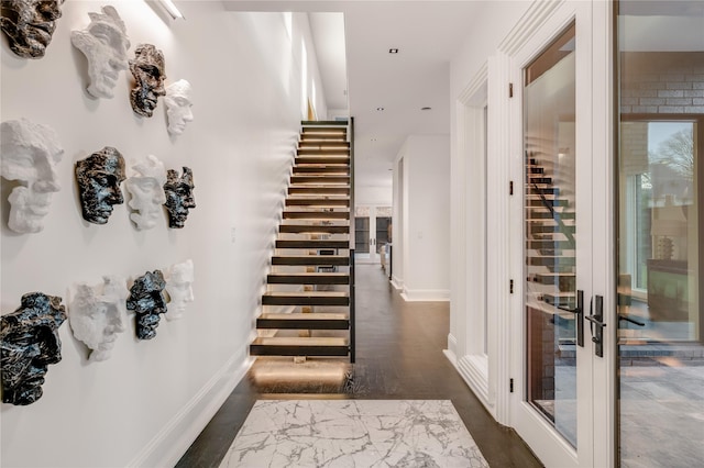 interior space featuring stairway and baseboards