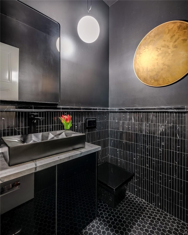 6404 Lakehurst Ave, Dallas, TX 75230 - bathroom with tile walls, tile patterned floors, vanity, and a wainscoted wall