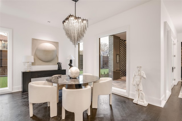 dining room featuring an inviting chandelier and baseboards