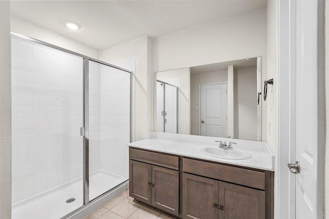 bathroom featuring vanity, a shower stall, and tile patterned floors