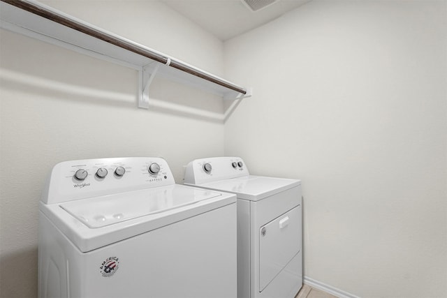 laundry room featuring baseboards, independent washer and dryer, and laundry area