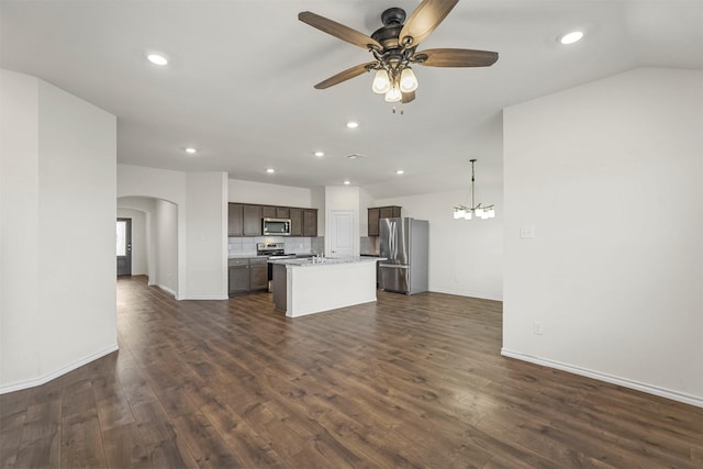 kitchen featuring dark brown cabinetry, open floor plan, a center island with sink, light countertops, and appliances with stainless steel finishes