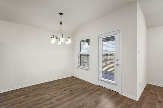 unfurnished dining area with dark wood finished floors, vaulted ceiling, a notable chandelier, and baseboards