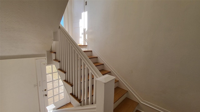 staircase with a textured wall