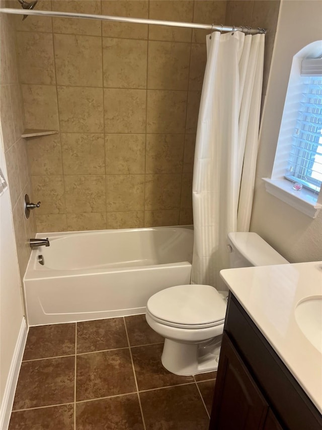 bathroom featuring vanity, toilet, shower / tub combo, and tile patterned flooring