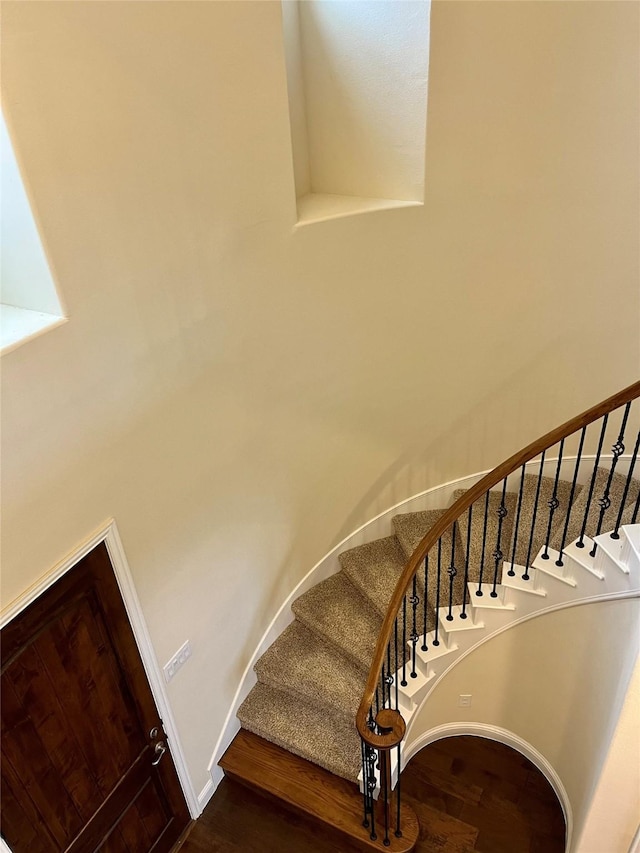 stairs featuring baseboards and wood finished floors