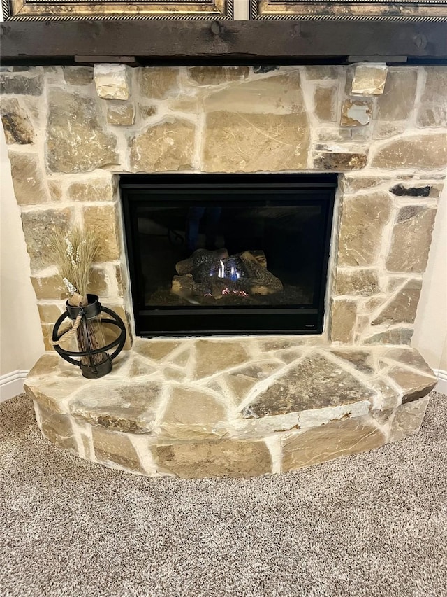 room details featuring a fireplace and baseboards