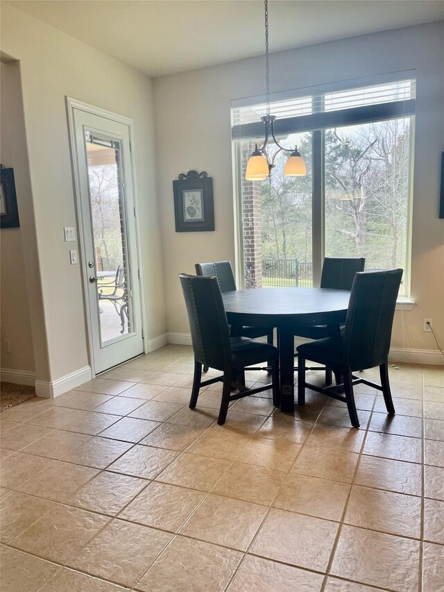 dining space with baseboards and plenty of natural light