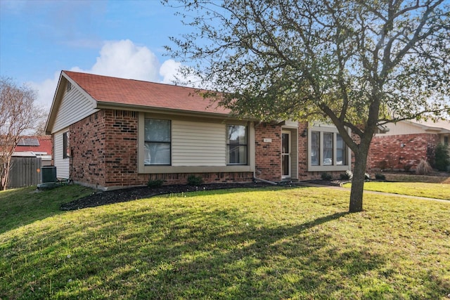 ranch-style home with brick siding, a front yard, and fence