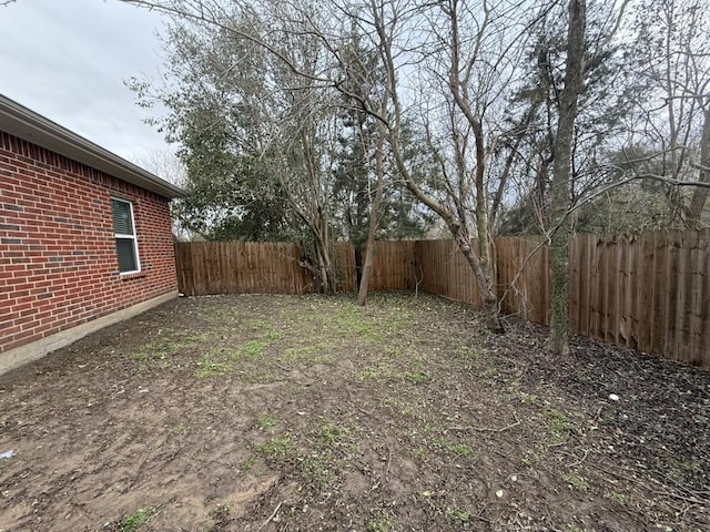 view of yard with a fenced backyard