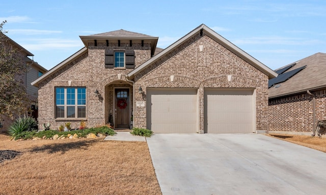 view of front of property with brick siding, roof with shingles, concrete driveway, and an attached garage