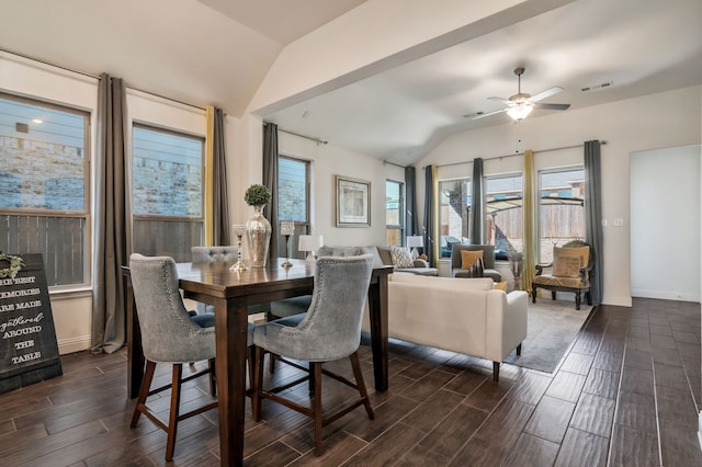 dining room featuring ceiling fan, lofted ceiling, baseboards, and wood tiled floor