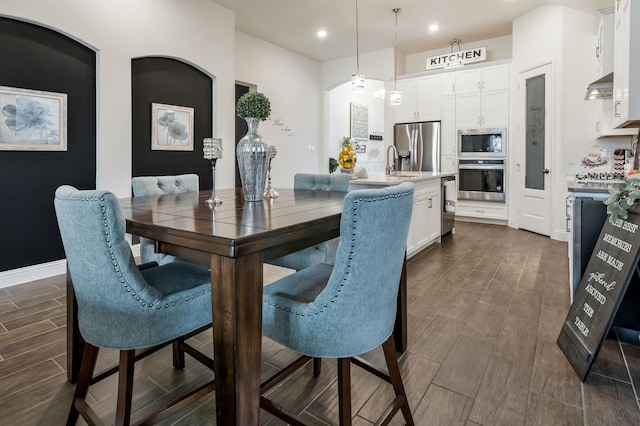 dining room featuring recessed lighting, baseboards, and wood tiled floor