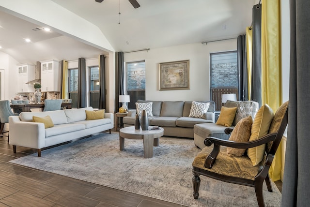 living room featuring lofted ceiling, a ceiling fan, and wood tiled floor