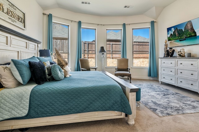 bedroom featuring lofted ceiling, carpet flooring, baseboards, and visible vents