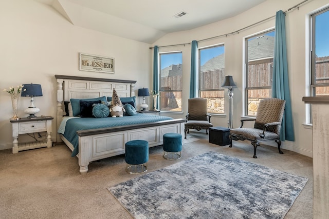 bedroom with visible vents, baseboards, carpet, and vaulted ceiling