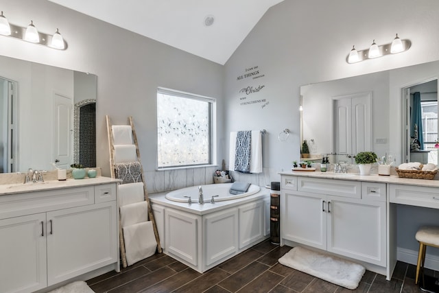 bathroom with vaulted ceiling, two vanities, wood finish floors, and a sink