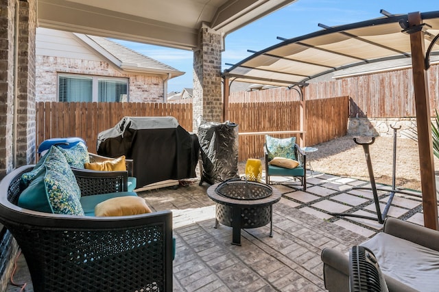 view of patio with a fire pit, fence, and grilling area