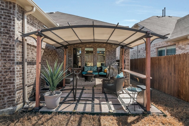 view of patio featuring outdoor lounge area and fence