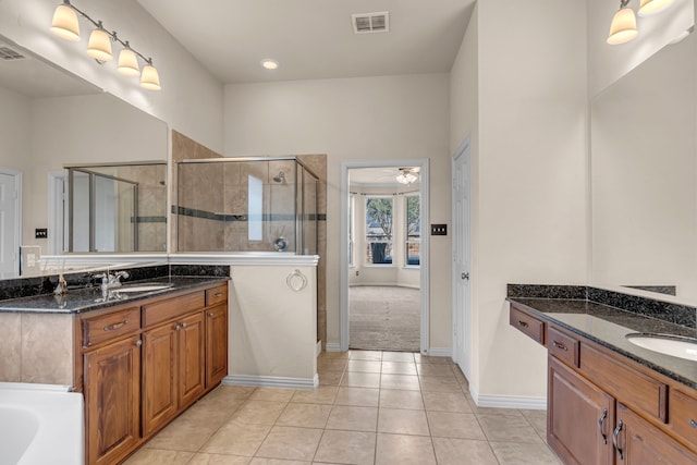 full bath with a sink, visible vents, a shower stall, and tile patterned floors