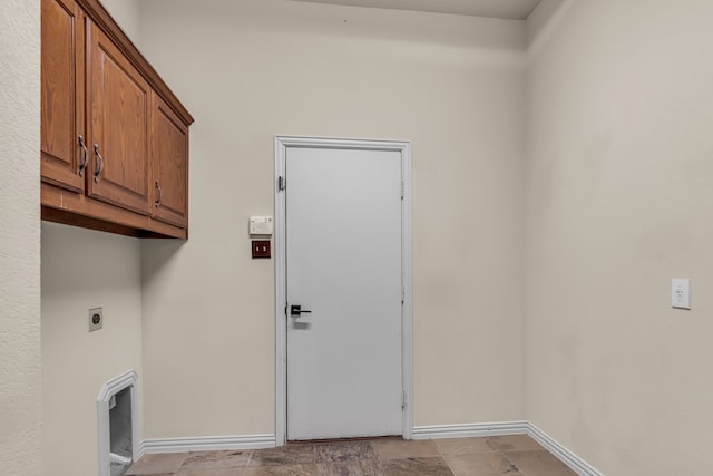 laundry room featuring cabinet space, electric dryer hookup, and baseboards