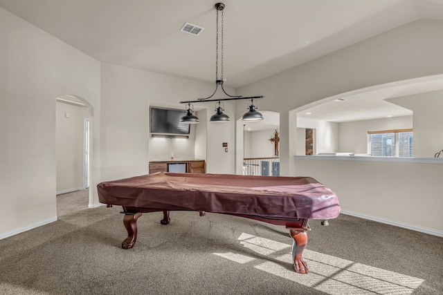 recreation room with vaulted ceiling, visible vents, arched walkways, and carpet floors