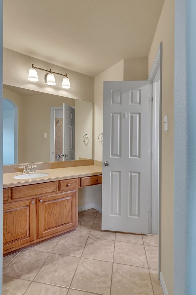 bathroom featuring tile patterned floors, vanity, and baseboards