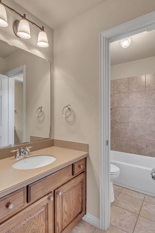 full bath featuring baseboards, toilet, vanity, and tile patterned flooring