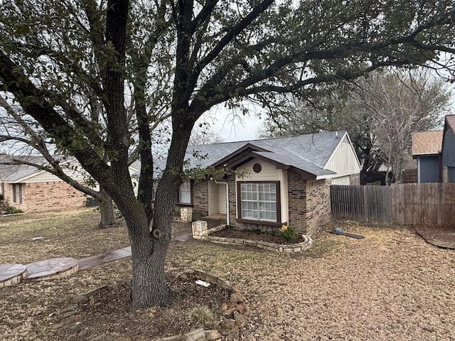 single story home with brick siding and fence