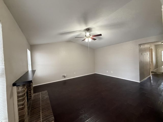 unfurnished living room featuring ceiling fan, baseboards, lofted ceiling, and dark wood-style flooring