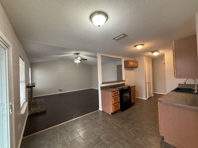 kitchen featuring visible vents, black range with electric stovetop, lofted ceiling, brown cabinets, and a sink