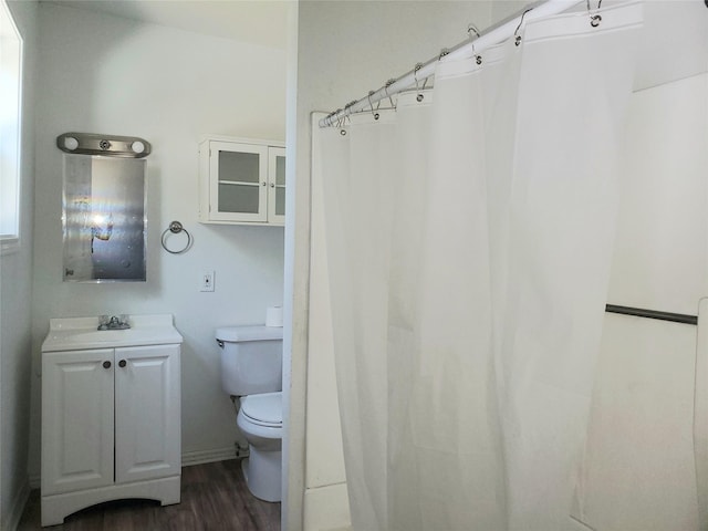 full bathroom featuring toilet, wood finished floors, and vanity