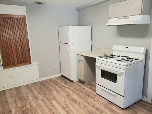 kitchen featuring under cabinet range hood, visible vents, white appliances, and light wood-style flooring