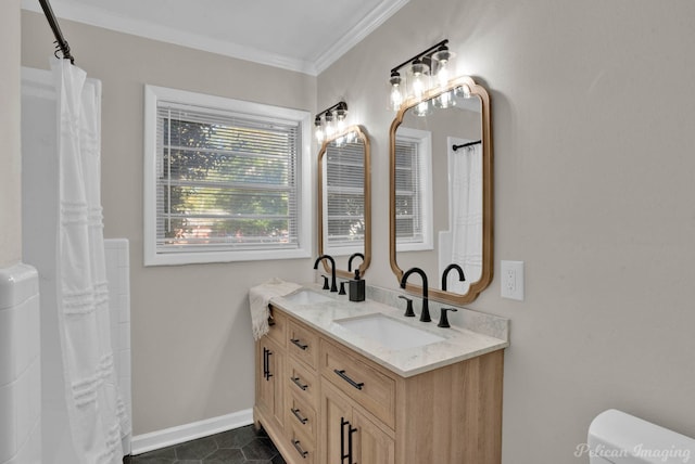 bathroom featuring a sink, baseboards, ornamental molding, and double vanity