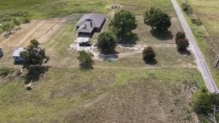 birds eye view of property with a rural view