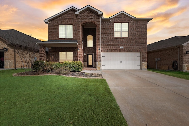 traditional home featuring brick siding, concrete driveway, a front yard, and a garage