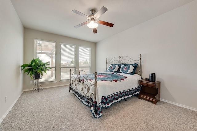 carpeted bedroom with a ceiling fan and baseboards