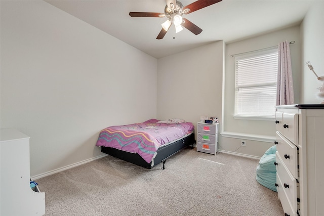 carpeted bedroom featuring a ceiling fan and baseboards