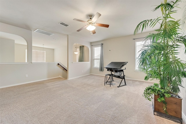 interior space with a healthy amount of sunlight, visible vents, and carpet floors