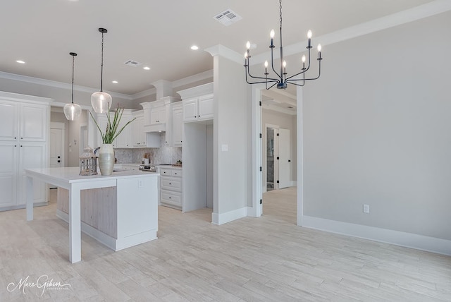 kitchen featuring visible vents, tasteful backsplash, white cabinetry, crown molding, and light countertops