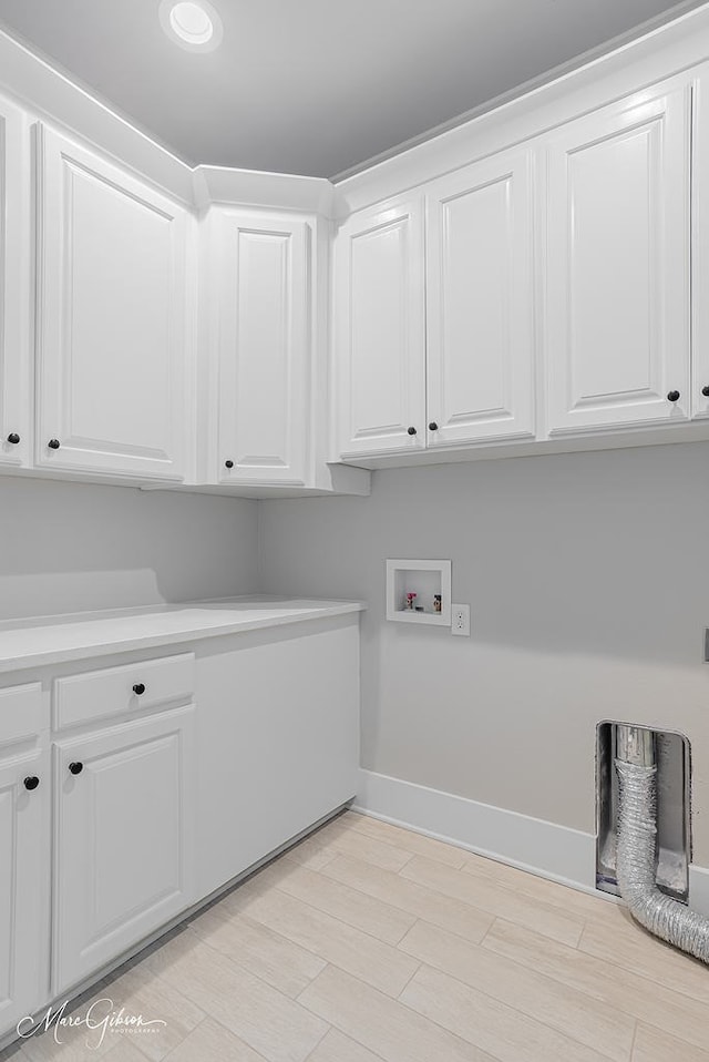 laundry room featuring baseboards, cabinet space, washer hookup, and light wood finished floors