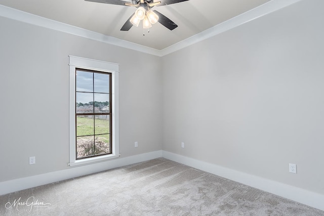 empty room featuring baseboards, a ceiling fan, carpet flooring, and crown molding